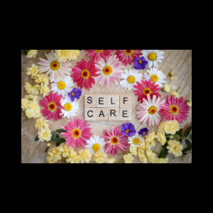 Canva image featuring self-care written in wood letter tiles surrounded by daisy flowers