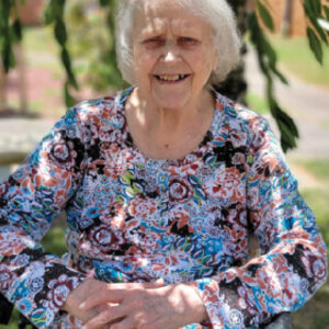 Cumberland Nursing and Rehab Resident, Loretta, pictured sitting in a chair outside on a bright sunny day.