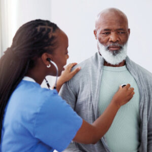 Female nurse listening to adult man's heart through stethoscope.