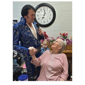 Cumberland Nursing and Rehab Resident visiting with Elvis impersonator